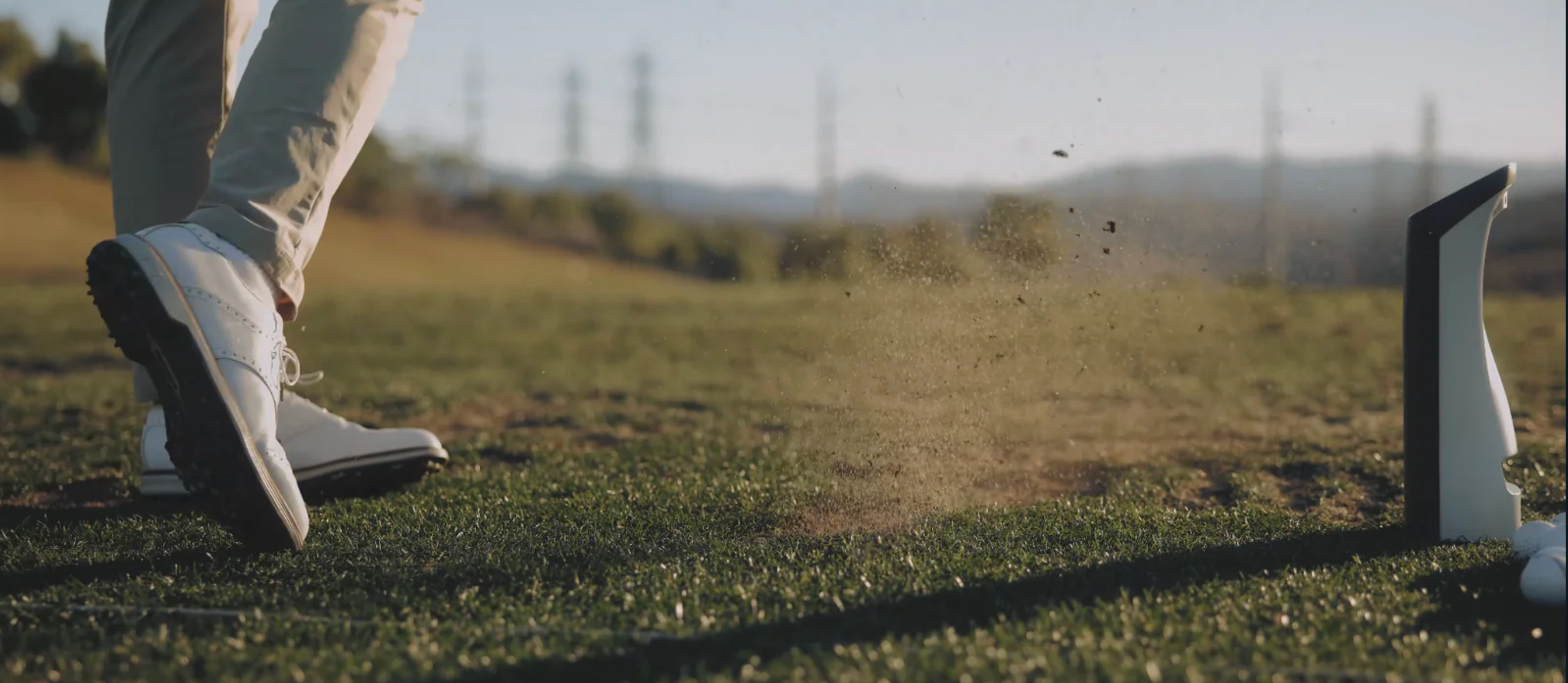 GOLFJOY Spica 3 portable golf launch monitor outside on the driving range.