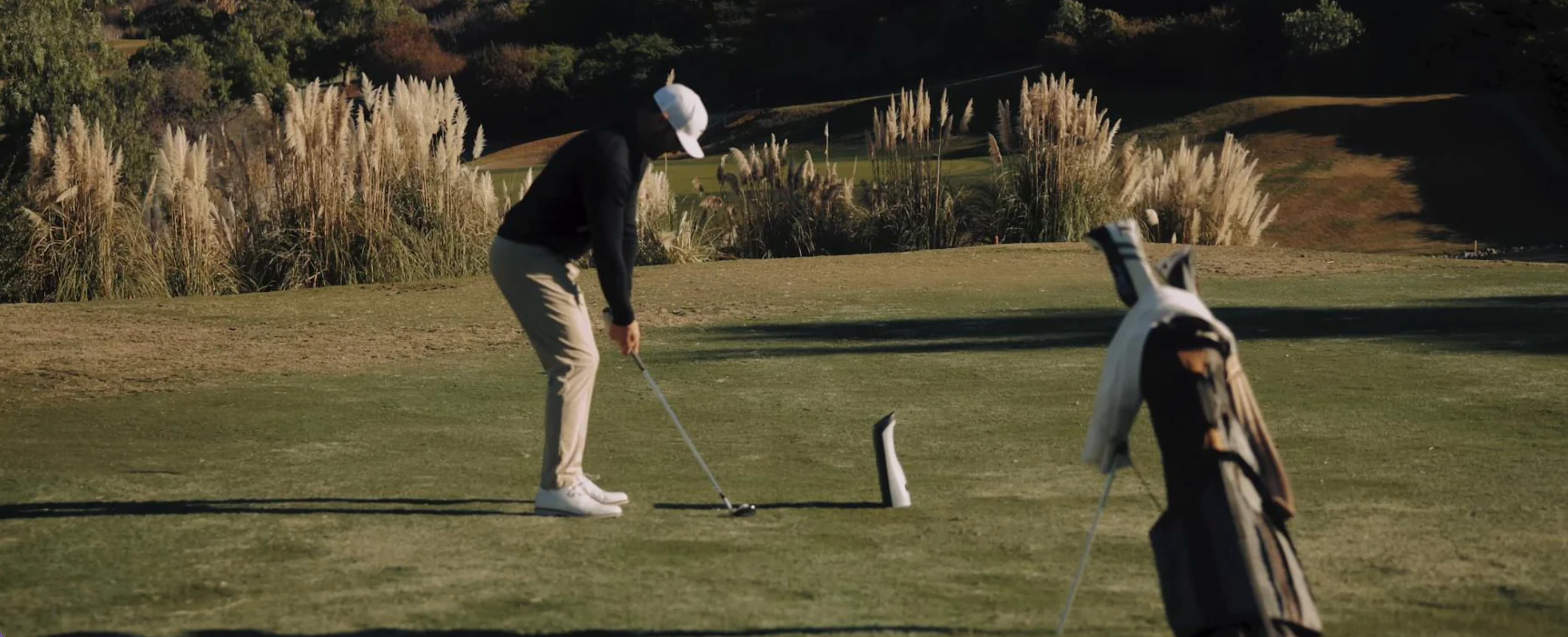 GOLFJOY Spica 3 portable golf launch monitor on the course.