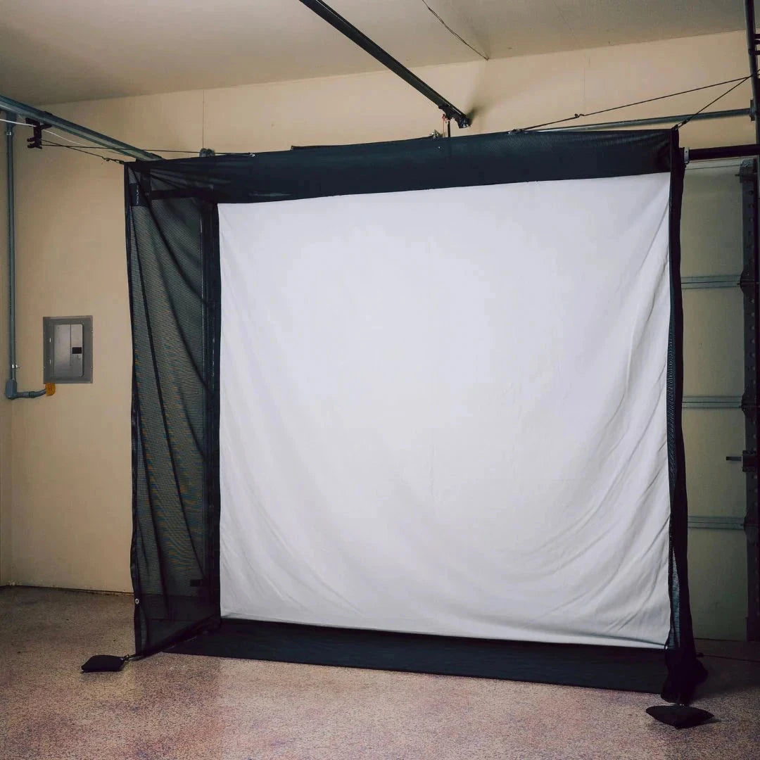 Retractable garage golf simulator impact screen with netting.