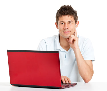 A man customize sitting at a desk with a red AllSportSystems Golf Simulator Bay or Enclosure.