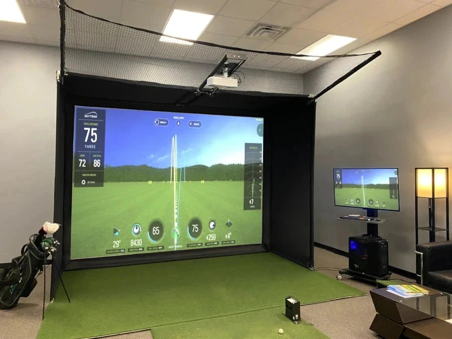 Transform your home into the ultimate golfing haven with the AllSportSystems Super Bay™ LITE™ Golf Simulator Safety Bay. Immerse yourself in breathtaking golf courses on a large screen while a side monitor delivers real-time stats. Nearby, a green mat stands ready for your swing, offering an exceptional blend of technology and sport right in your own living space.