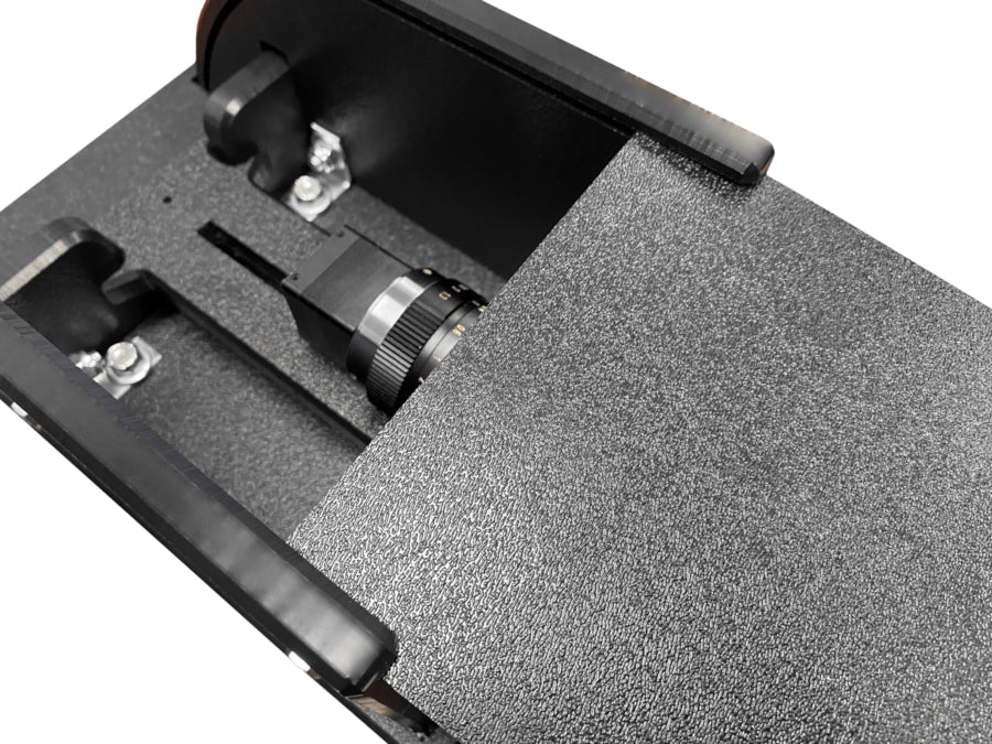 Close-up of the Rugged Video Camera Shield Enclosure by AllSportSystems, showcasing its black textured design and partially exposed lens, complete with a subtle red logo, crafted to enhance your golf experience.