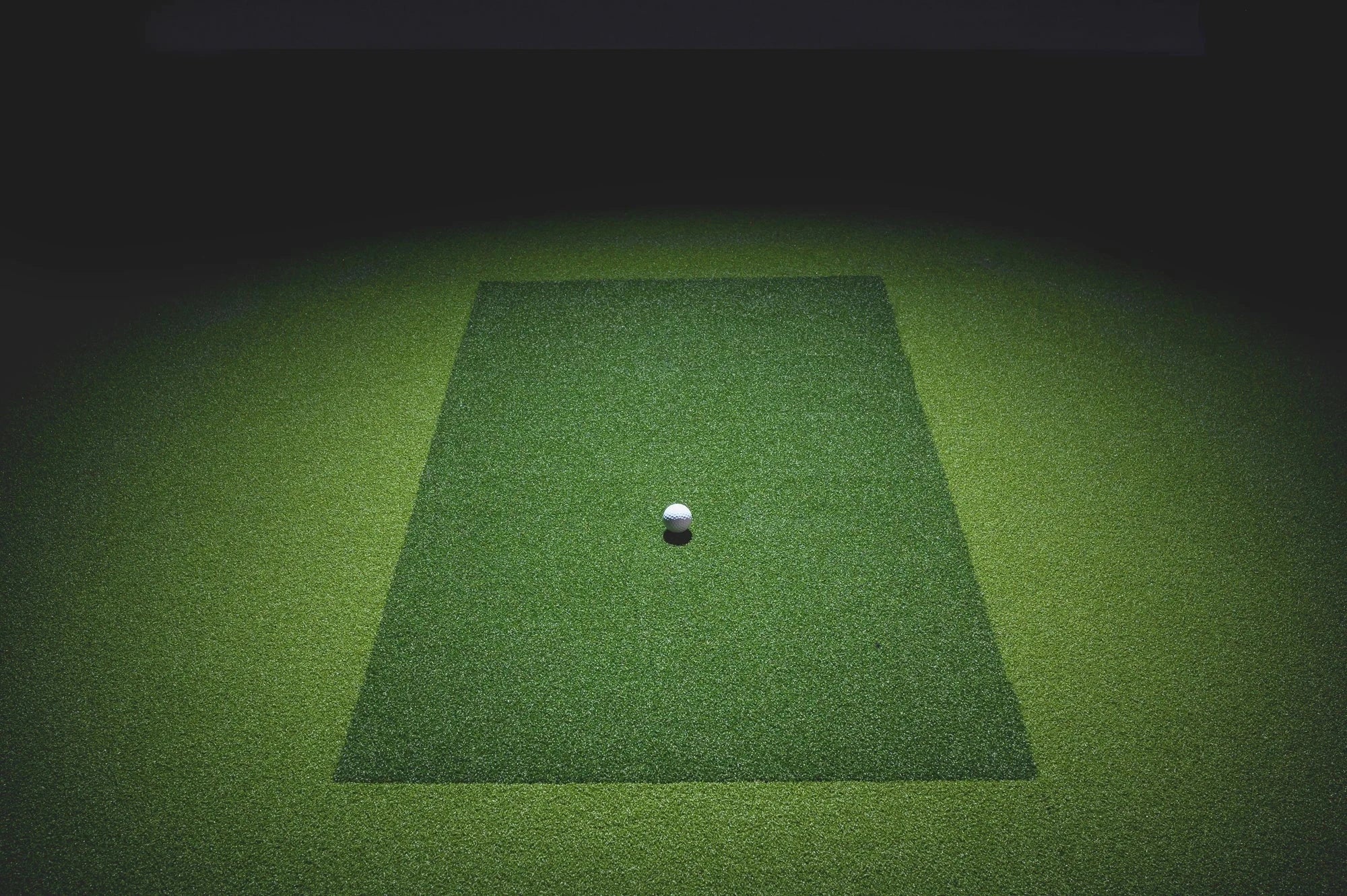 High end home golf simulator bays and enclosures with full golf flooring and solid side walls from SimBooth.