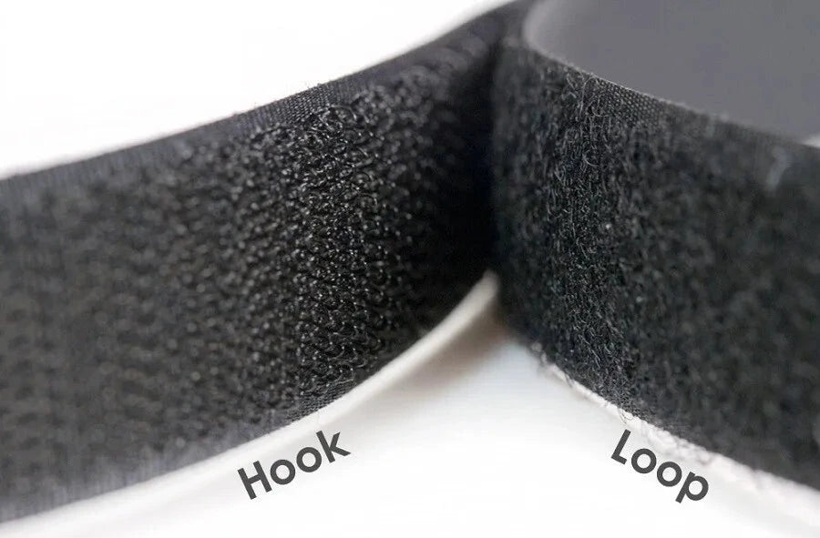 Close-up of black VELCRO fasteners with labels indicating each side, perfect for organizing your AllSportSystems golf accessories.