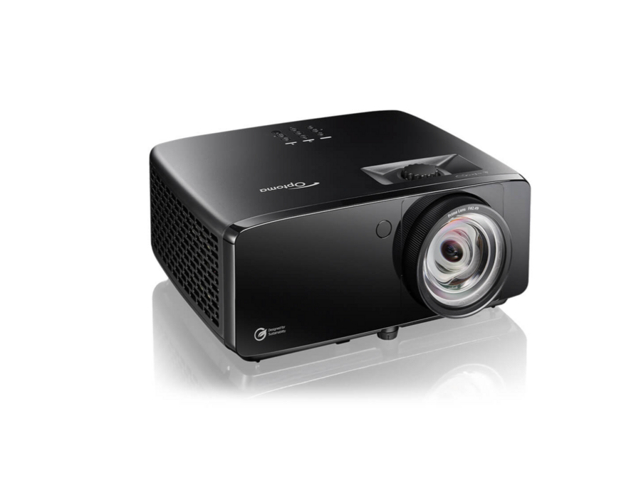 A black Optoma projector with a large lens is displayed on a white background, showing control buttons on top and ventilation grilles on the side.