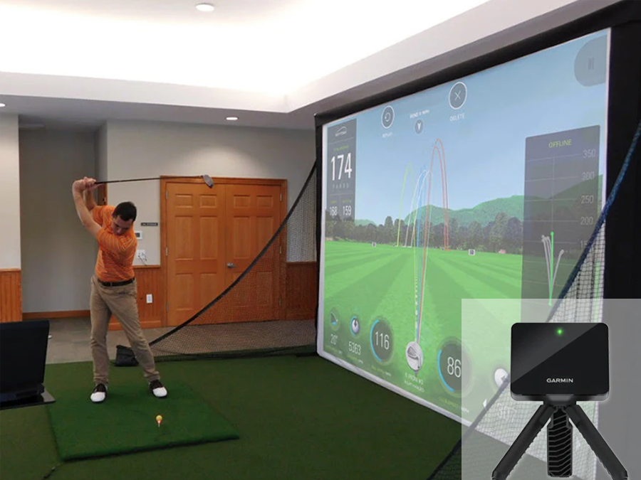 A complete Garmin R10 home golf simulator kit which includes an indoor golf simulator bay for small rooms, short throw projector, screen, and mat from ALLSPORTSYSTEMS.