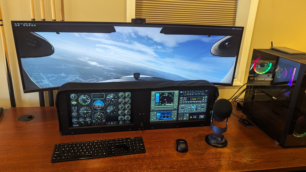 A flight simulator dash panel with two touchscreen monitors and knobster running Air Manager.