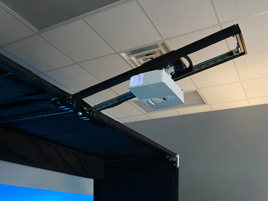 AllSportSystems SkyRail+ Cage Attached Golf Simulator Projector Mount for DIY Bays mounted on the ceiling.