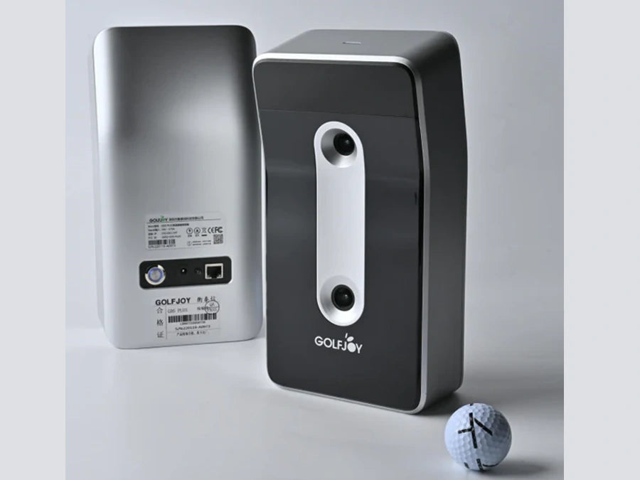 Two GOLFJOY GDS Plus Launch Monitors are shown, one featuring the back with ports and labels to highlight its advanced capabilities. A golf ball waits in front, poised for use.